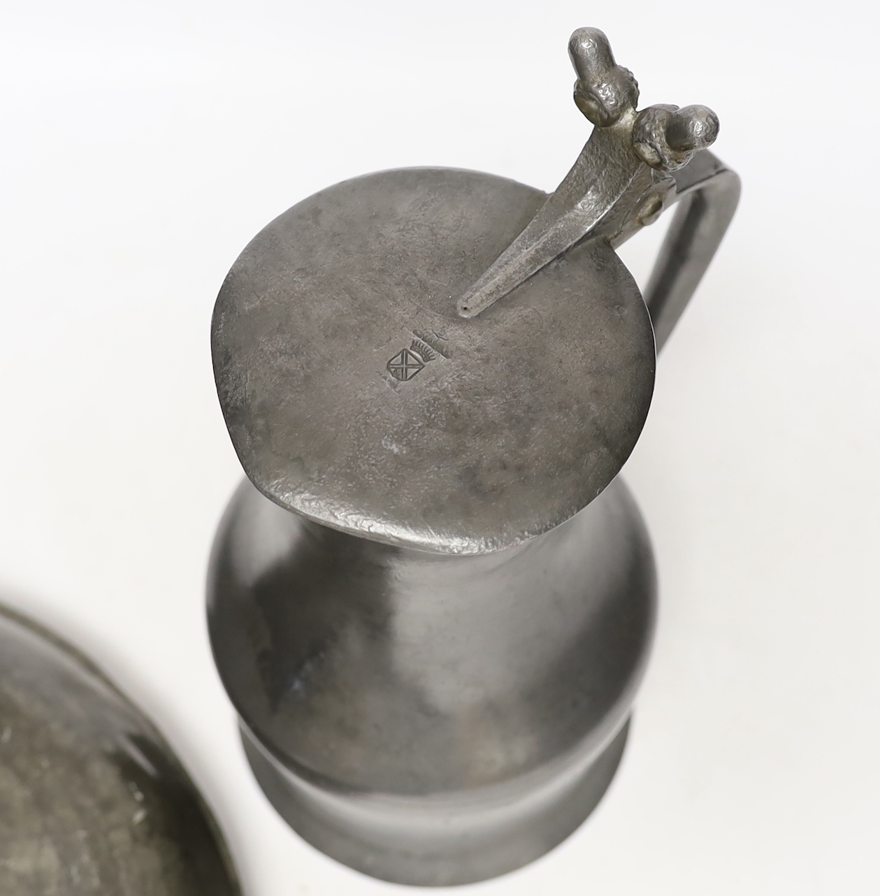 An 18th/19th century pewter measure and an 19th century pewter pan, 46cm long